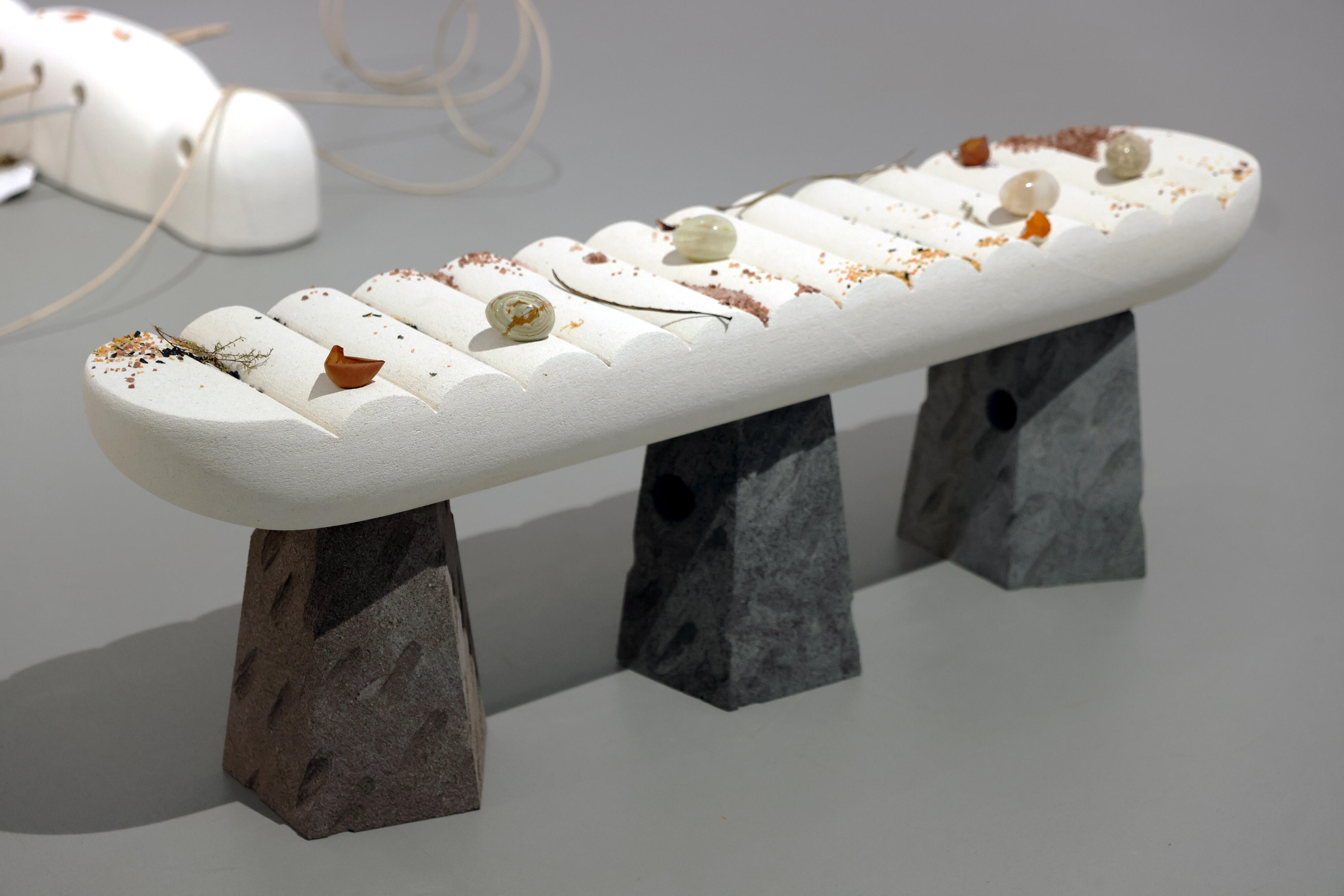 <p><strong>Sorawit Songsataya</strong>,<em>&nbsp;Ranad</em> detail from the exhibition&nbsp;<em>Fibrous Soul,</em> 2024. Taranaki&nbsp;andesite, Ōamaru limestone, onyx,&nbsp;dried plant. Taranaki andesite&nbsp;carving by Donald Buglass. Photo&nbsp;courtesy of the artist and Govett-Brewster Art Gallery</p>
