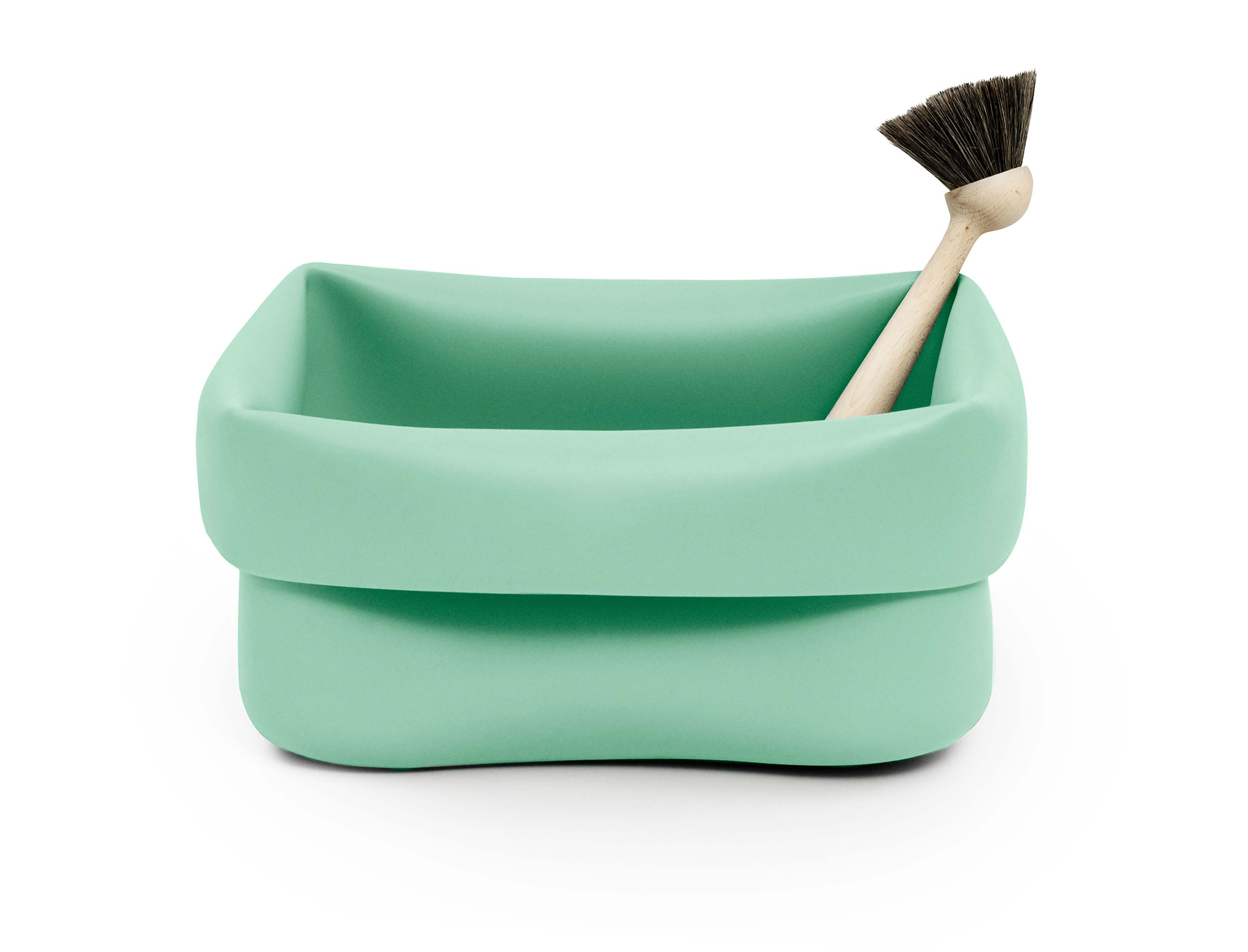 <p>Ole Jensen (born 1958)<br />
Manufactured by Normann Copenhagen (est 1999)</p>

<p><em>Washing-up Bowl and Brush</em></p>

<p>1996 (designed), rubber, beech, natural bristles<br />
on loan from the Designmuseum Danmark</p>

<p>With the <em>Washing-up Bowl and Brush</em> Ole Jensen takes a mundane, unglamorous household task and transforms it into a playful, vibrant and sensuous design experience. Jensen&rsquo;s washing-up bowl is a bold, sculptural embrace of functionality. Made from synthetic rubber, the material is pleasant to touch, water-resistant and reduces the clanging sound of rattling dishes. Although the scrubbing brush signals its intended use, the washing bowl has multiple potential uses: toy basket, a footbath, a pot for flowers, or, in the case of the Museum of Modern Art in New York, a champagne cooler.</p>