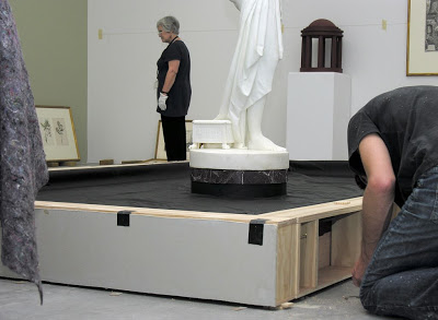 <p>Th sides going on the pond as curator Mary Kisler oversees the installation progress</p>