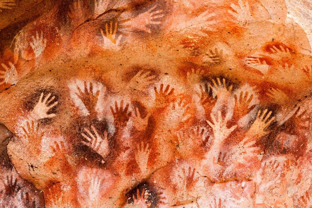 <p>Ancient hand impressions and art at the Cueva de las Manos (Cave of the Hands) in Argentina, which date back more than 9000 years. Photo: Vibrant Pictures / Alamy Stock Photo</p>
