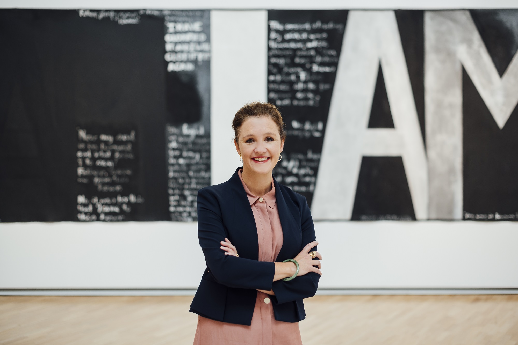 <p>Image: New Auckland Art Gallery Director Kirsten Paisley</p>

<p>Image Credit:&nbsp; Photography by Rohan Thomson. Artwork shown in background: <strong>Colin McCahon</strong>,<em> Victory over death 2</em>, 1970, National Gallery of Australia. Gift of the New Zealand Government 1978</p>