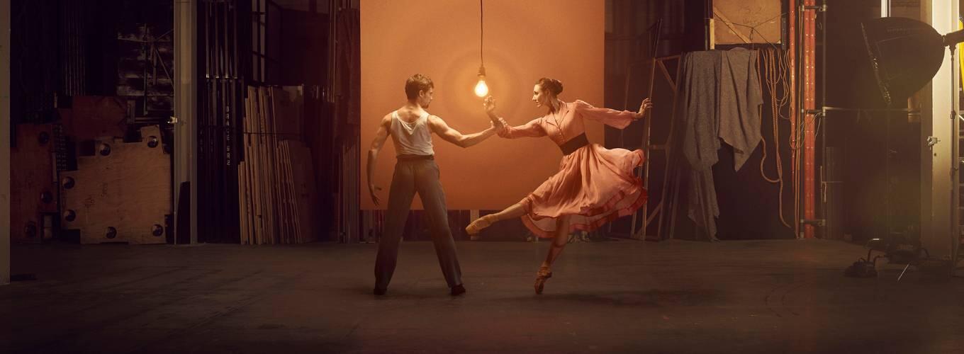 Performers from A Streetcar Named Desire dancing in front of a light bulb