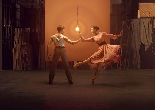 Performers from A Streetcar Named Desire dancing in front of a light bulb