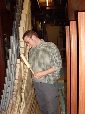 <p>Organ voicer Markus Linden installing pipes in the Auckland Town Hall.</p>
