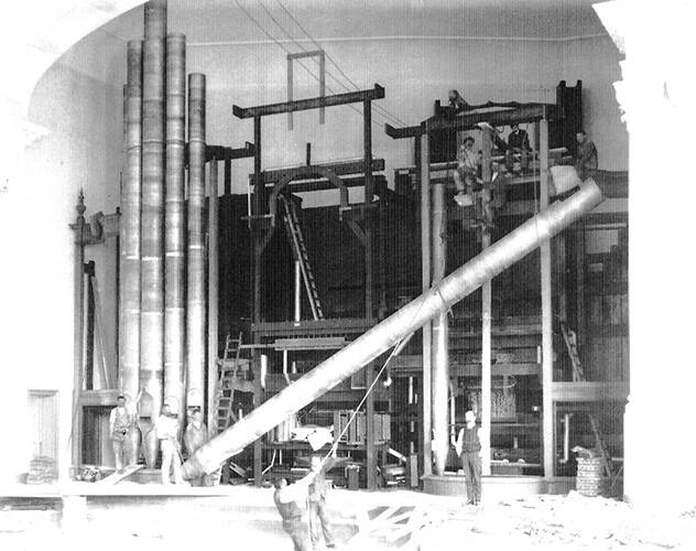 <p>The bottom C sharp pipe of the 32-foot Double Open Diapason (metal) being hoisted into place in 1911 | George Grey Collection</p>
