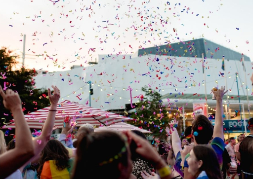 a crowded event with confetti in the air