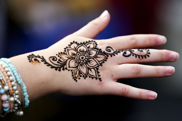 Henna art on hand with jewelry 