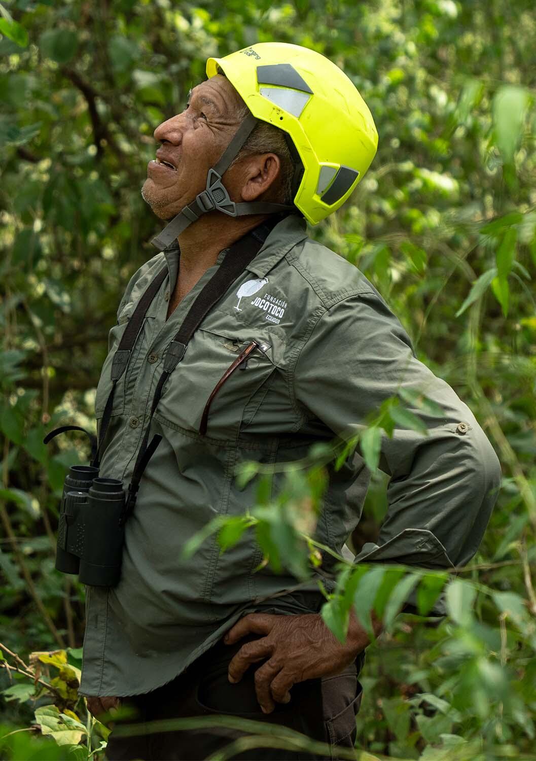 Fundación de Conservación Jocotoco ranger Patricio Reyes Ramírez looking up into a tree
