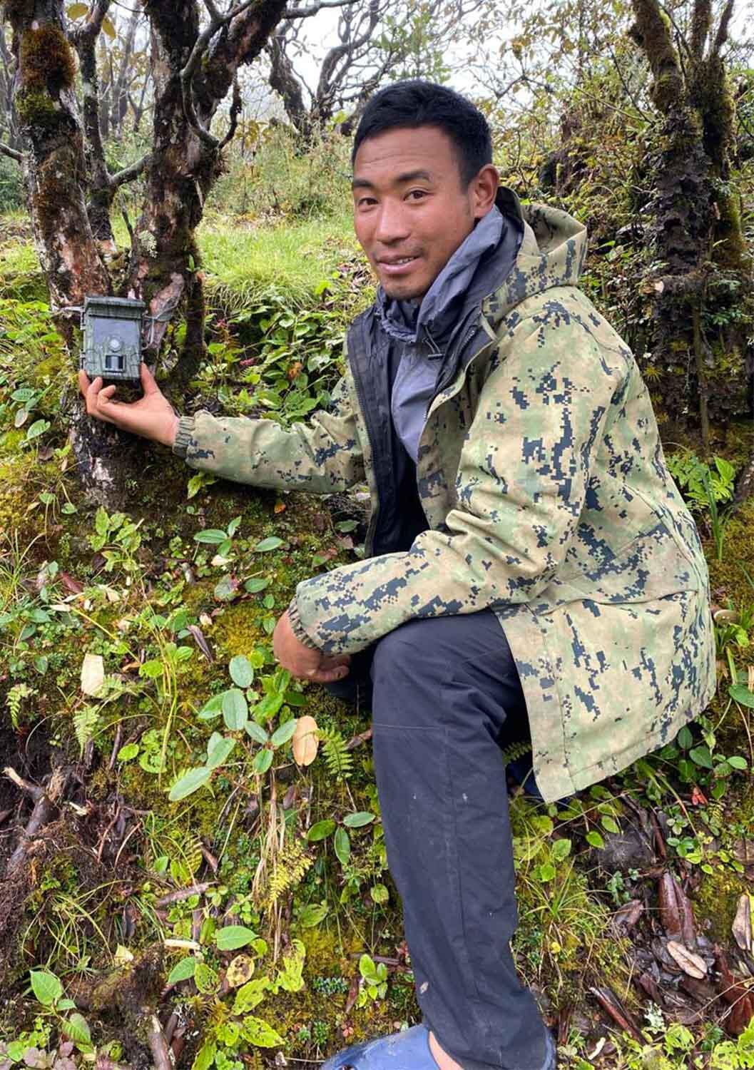 Mr. Phurba Sherpa from the Red Panda Network setting up a camera trap